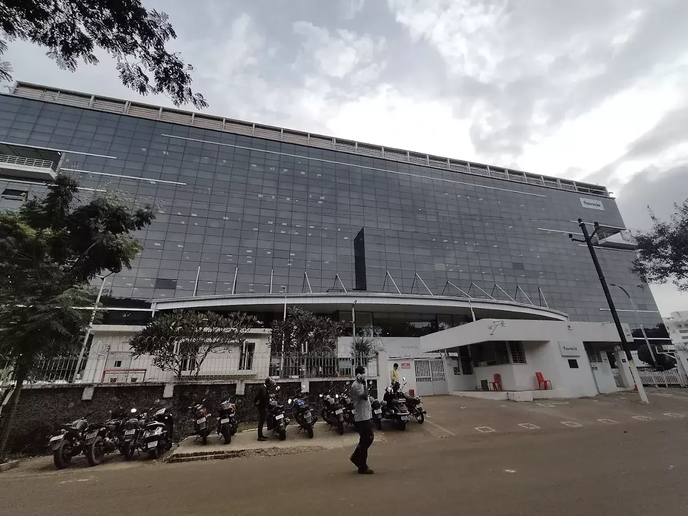 Industrial roof modernization for Faurecia Clean Mobility, Bhosari, Pune: Sustainable standing seam retrofit, turbo ventilators, and daylighting PC sheets by Rishonn & Reyansh for automotive technology manufacturing plants.